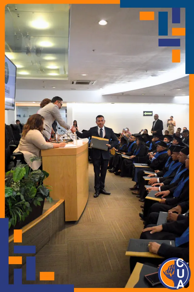 Entrega de reconocimiento frente a los graduados reunidos en el auditorio. Graduación del 14 de junio de 2025.